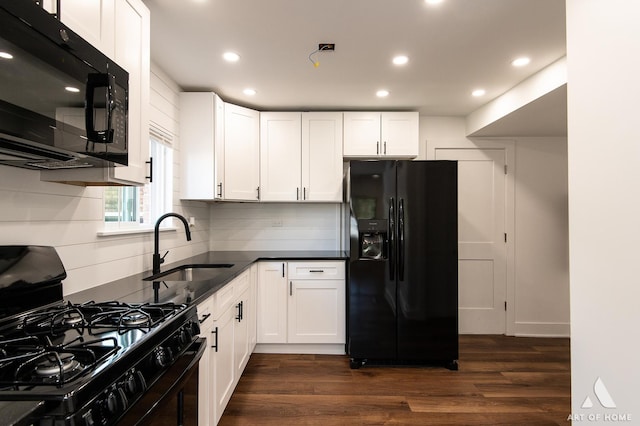 kitchen featuring black appliances, a sink, dark wood-type flooring, white cabinets, and recessed lighting