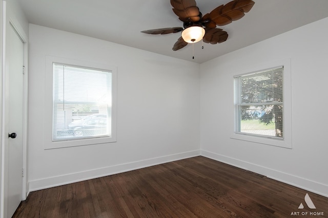 unfurnished room featuring baseboards, dark wood-type flooring, and ceiling fan