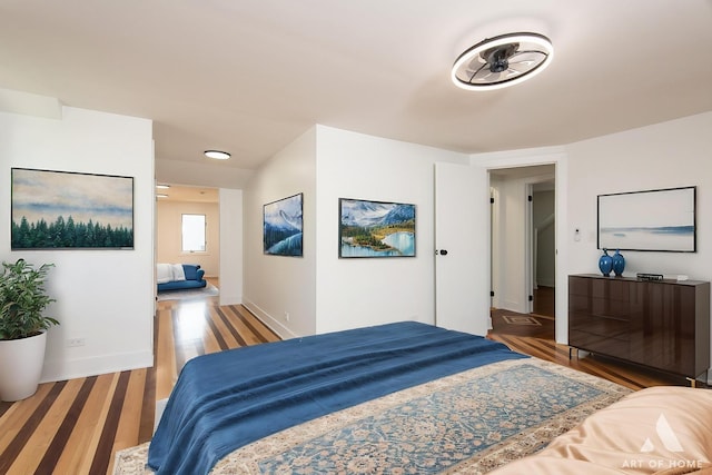 bedroom with wood finished floors and baseboards