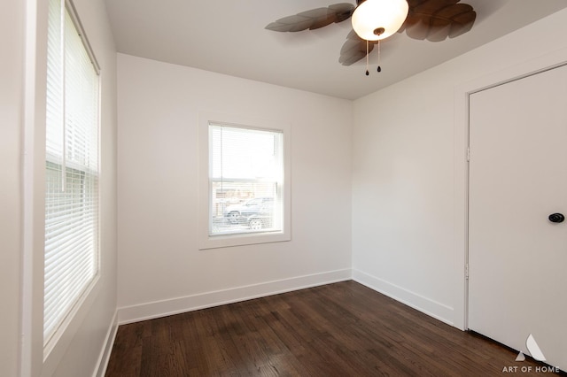 unfurnished room featuring dark wood-type flooring, baseboards, and ceiling fan