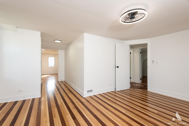unfurnished room featuring baseboards and light wood-style floors