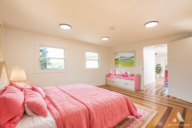 bedroom featuring baseboards and wood finished floors