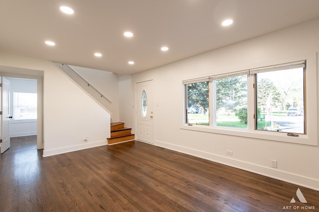 foyer with plenty of natural light, dark wood-style floors, stairway, baseboards, and recessed lighting