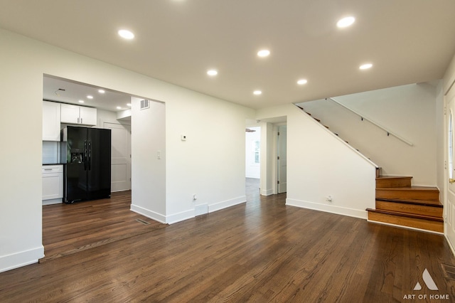 unfurnished living room featuring stairway, recessed lighting, dark wood-style flooring, and baseboards