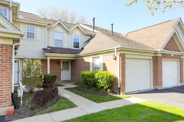 1224 Clearview Ct, Buffalo Grove, IL 60089 - multi unit property featuring an attached garage, asphalt driveway, brick siding, and roof with shingles