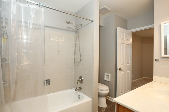 full bath with toilet, shower / tub combination, vanity, and tile patterned floors