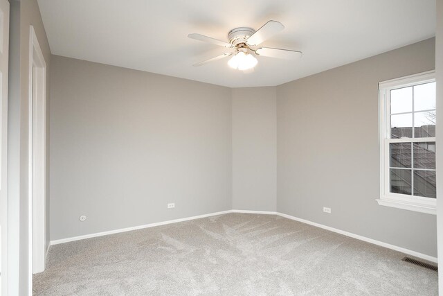 unfurnished room with carpet floors, a ceiling fan, and baseboards