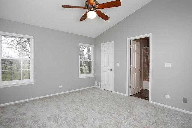 1224 Clearview Ct, Buffalo Grove, IL 60089 - unfurnished bedroom featuring carpet, multiple windows, lofted ceiling, baseboards, and connected bathroom