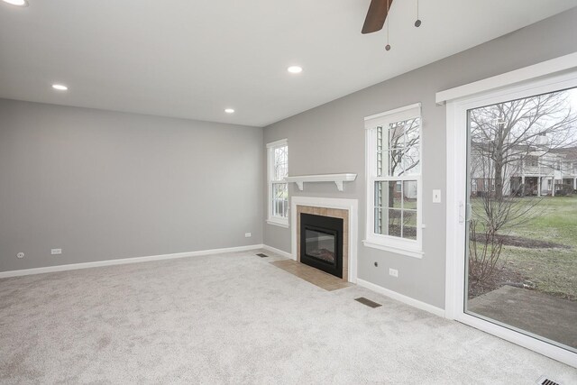 unfurnished living room featuring carpet flooring, recessed lighting, baseboards, a fireplace, and ceiling fan