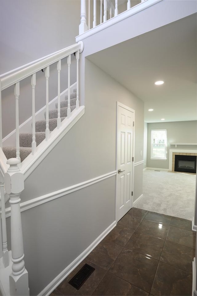 1224 Clearview Ct, Buffalo Grove, IL 60089 - stairs with carpet, recessed lighting, a fireplace, tile patterned flooring, and baseboards