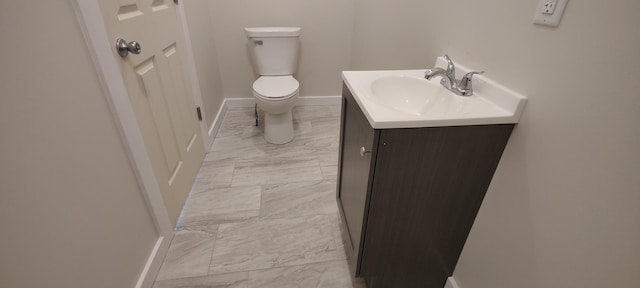 407 Allen St, Belvidere, IL 61008 - bathroom with toilet, marble look tiles, vanity, and baseboards