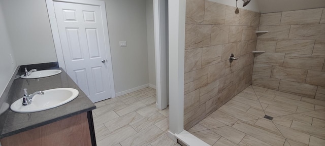 407 Allen St, Belvidere, IL 61008 - bathroom featuring tiled shower, double vanity, and baseboards