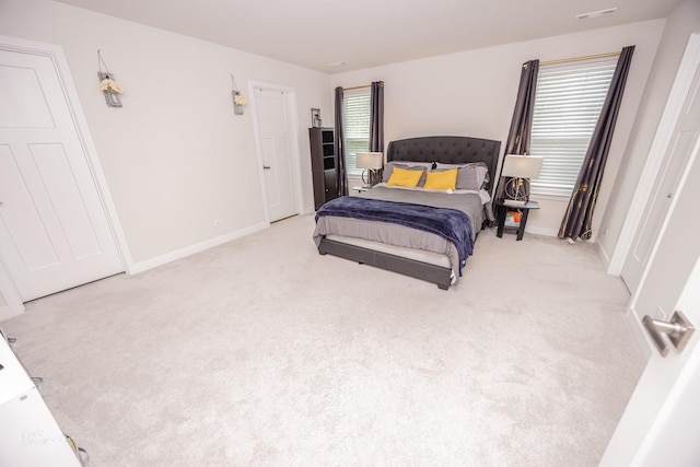 carpeted bedroom featuring baseboards
