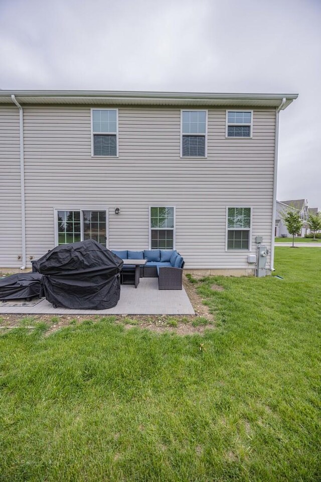 back of house featuring an outdoor hangout area, a patio, and a lawn
