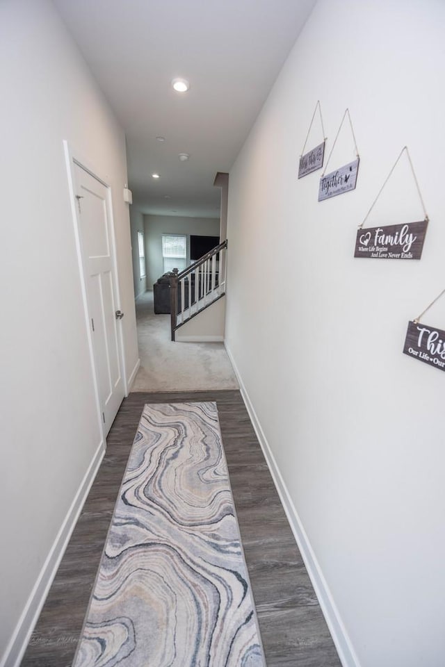 hall featuring baseboards, dark wood-style flooring, recessed lighting, and stairs