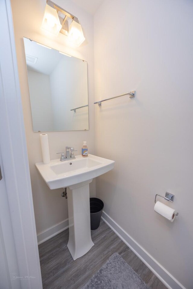 bathroom featuring baseboards and wood finished floors
