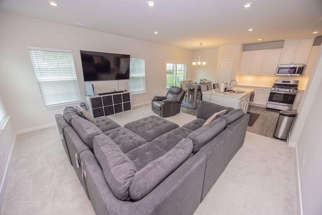 living room featuring a chandelier, light colored carpet, recessed lighting, and baseboards