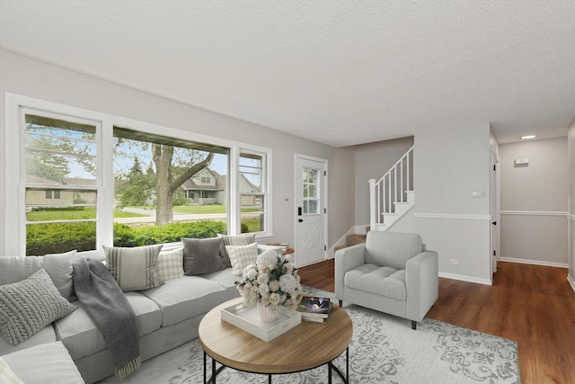 206 Villa Ave, Lake Villa, IL 60046 - living room with wood finished floors, stairs, a textured ceiling, and baseboards