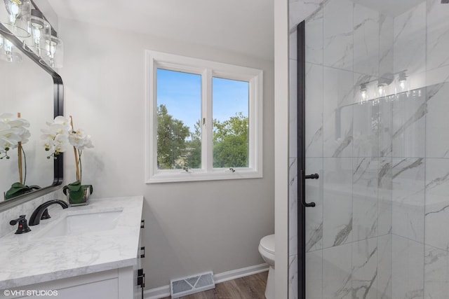 206 Villa Ave, Lake Villa, IL 60046 - bathroom with vanity, a marble finish shower, toilet, baseboards, and wood finished floors