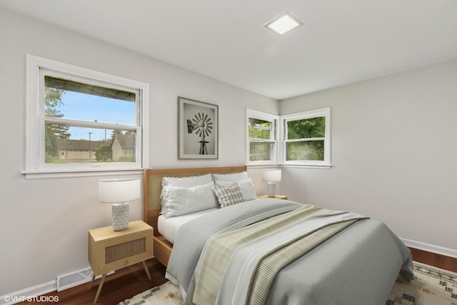 206 Villa Ave, Lake Villa, IL 60046 - bedroom with multiple windows, baseboards, and wood finished floors