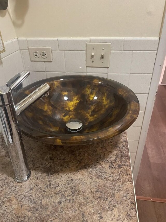 detailed view of a sink and a wainscoted wall