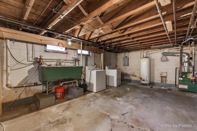basement with water heater, washer and dryer, a sink, electric panel, and a heating unit