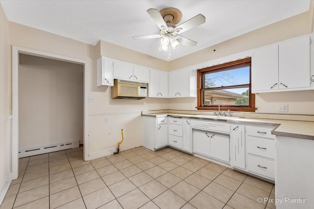 kitchen featuring white microwave, a baseboard heating unit, a sink, white cabinetry, and ceiling fan