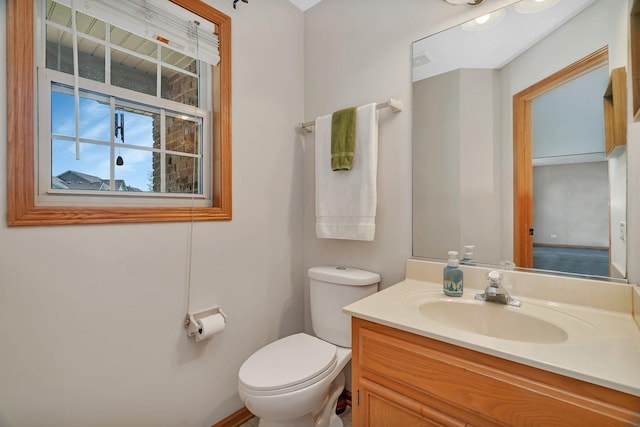 bathroom featuring toilet and vanity