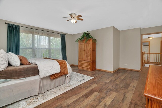 bedroom featuring wood finished floors, baseboards, and ceiling fan