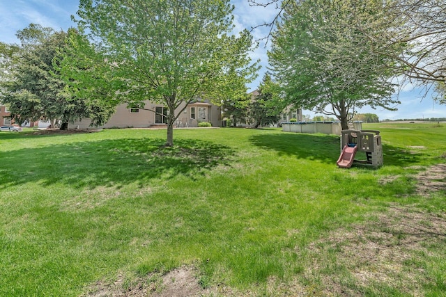 view of green lawn featuring an outdoor pool