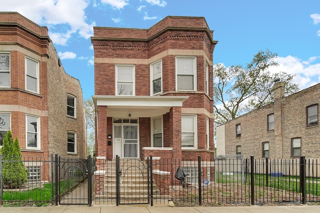 5733 S Morgan St, Chicago, IL 60621 - view of property with brick siding, a gate, a fenced front yard, and a porch