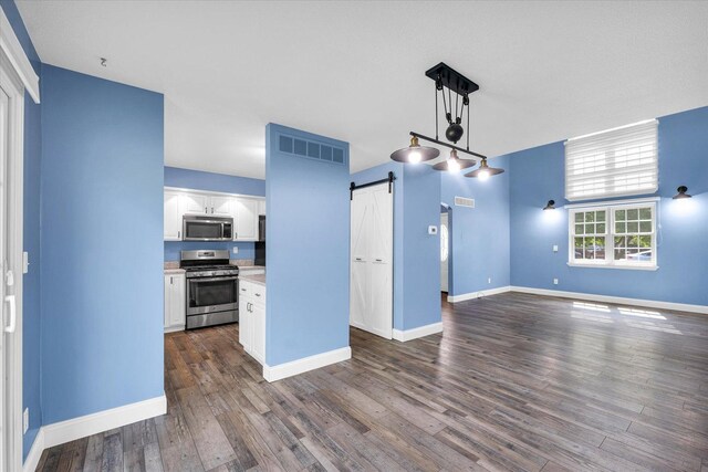 19 Nightingale Cir, Camargo, IL 61919 - unfurnished living room with a barn door, dark wood-style floors, and baseboards