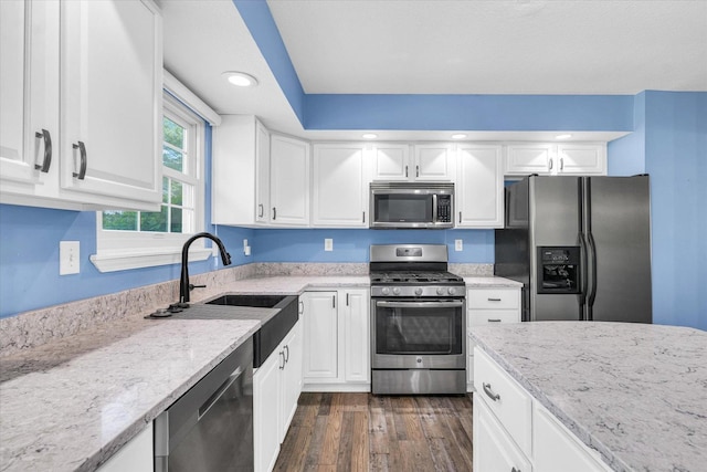 19 Nightingale Cir, Camargo, IL 61919 - kitchen featuring stainless steel appliances, dark wood-style flooring, light stone counters, white cabinetry, and a sink