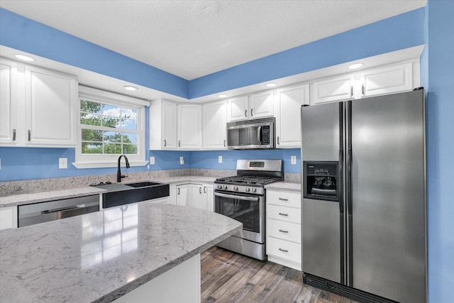 19 Nightingale Cir, Camargo, IL 61919 - kitchen featuring stainless steel appliances, a sink, white cabinetry, wood finished floors, and recessed lighting
