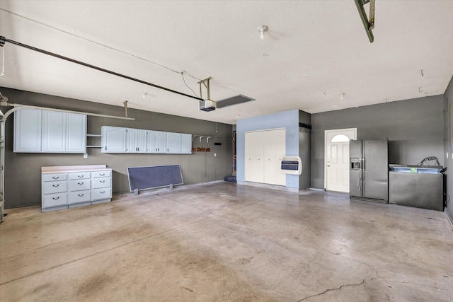 19 Nightingale Cir, Camargo, IL 61919 - garage featuring refrigerator with ice dispenser, heating unit, and a garage door opener