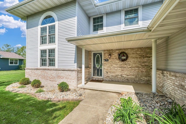 19 Nightingale Cir, Camargo, IL 61919 - property entrance featuring brick siding, covered porch, and a lawn