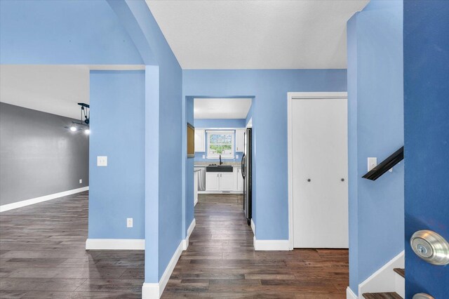19 Nightingale Cir, Camargo, IL 61919 - hallway with a sink, dark wood-type flooring, and baseboards