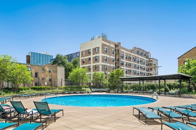 community pool featuring a patio and fence