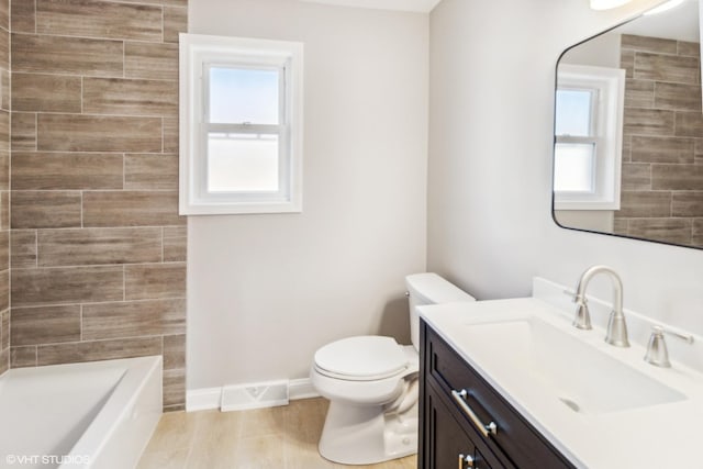 bathroom featuring toilet, baseboards, vanity, and a shower