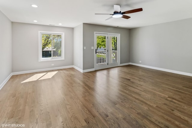 unfurnished room with a ceiling fan, baseboards, recessed lighting, and wood finished floors