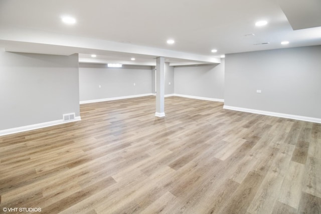 finished below grade area featuring recessed lighting, baseboards, and light wood-style floors