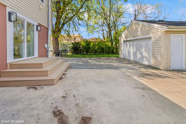 detached garage featuring fence