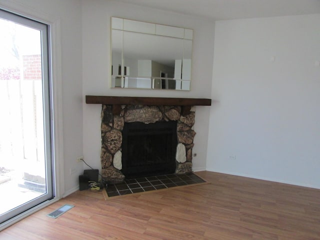 detailed view of wood finished floors and a fireplace
