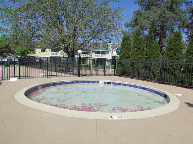 view of swimming pool featuring fence