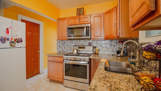 417 52nd Ave, Bellwood, IL 60104 - kitchen featuring appliances with stainless steel finishes, a sink, tasteful backsplash, and light stone countertops
