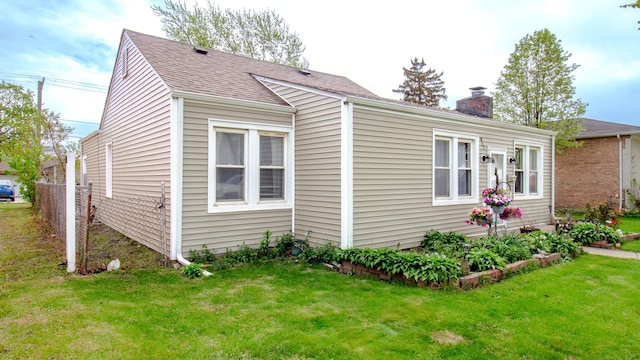 417 52nd Ave, Bellwood, IL 60104 - view of side of home featuring a chimney and roof with shingles