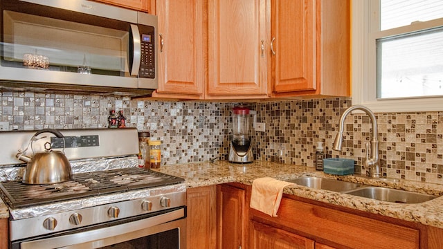 417 52nd Ave, Bellwood, IL 60104 - kitchen with appliances with stainless steel finishes, a sink, decorative backsplash, and light stone countertops