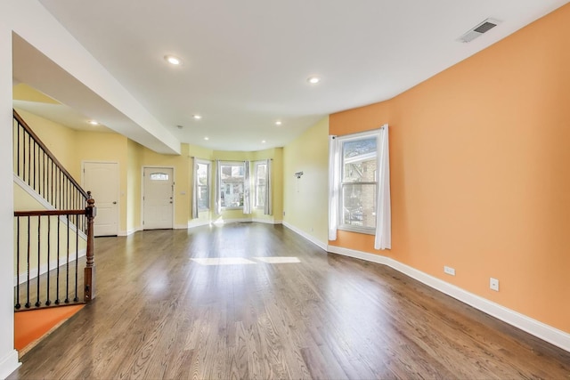 4723 W Shakespeare Ave, Chicago, IL 60639 - unfurnished living room with baseboards, dark wood-style floors, stairway, and recessed lighting