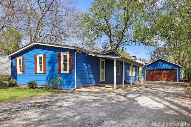 view of front facade featuring a garage and an outdoor structure