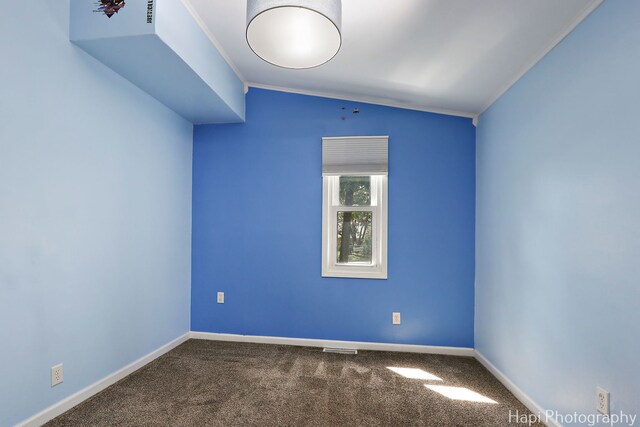 unfurnished room featuring ornamental molding, carpet floors, and baseboards